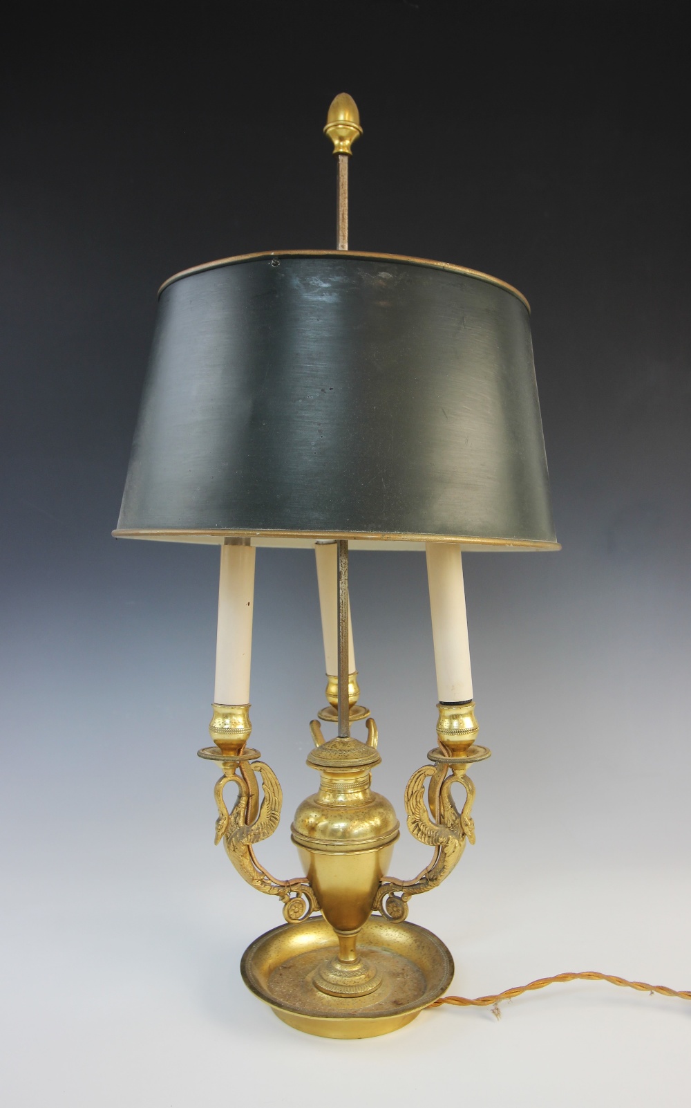 A Regency style ormolu student's lamp, modelled as a central vase issuing three swan form