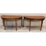 A pair of George III mahogany demi-lune side tables, each with ebonised inlay, on legs of square
