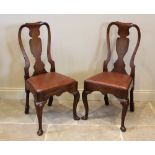 A pair of George I walnut side chairs, each with a vase shaped splat over a drop in upholstered seat