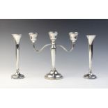 A three-branch silver candelabra by Mappin & Webb, Birmingham 1973, (weighted) 22.8cm high, together