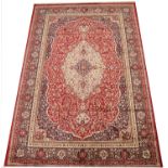 A full pile Kashmir carpet, with a traditional floral medallion design against a red ground, 200cm x