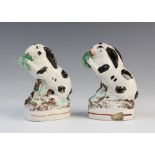 An unusual pair of Staffordshire rabbits, 19th century, each black and white patched rabbit modelled