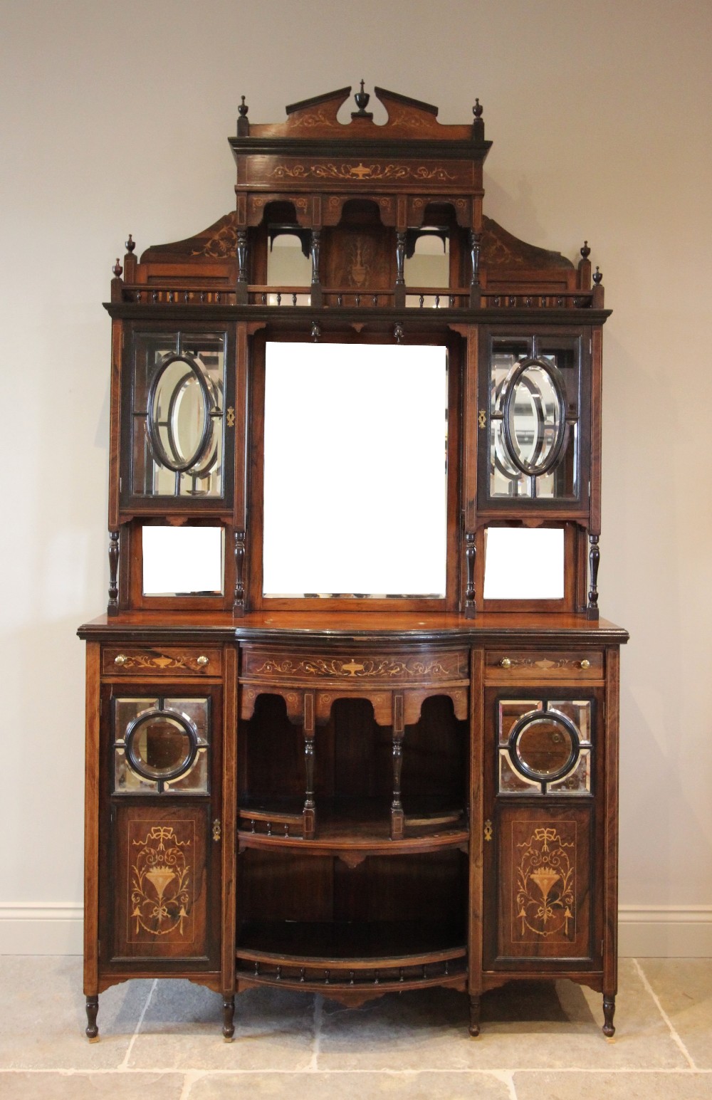 A late Victorian rosewood mirror back chiffonier, the architectural high back with a broken pediment