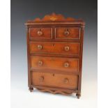 A 19th century mahogany apprentice chest, with an arrangement of two short and three long drawers,