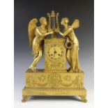 A late 19th century French Empire style gilt metal mantel clock, the case surmounted with