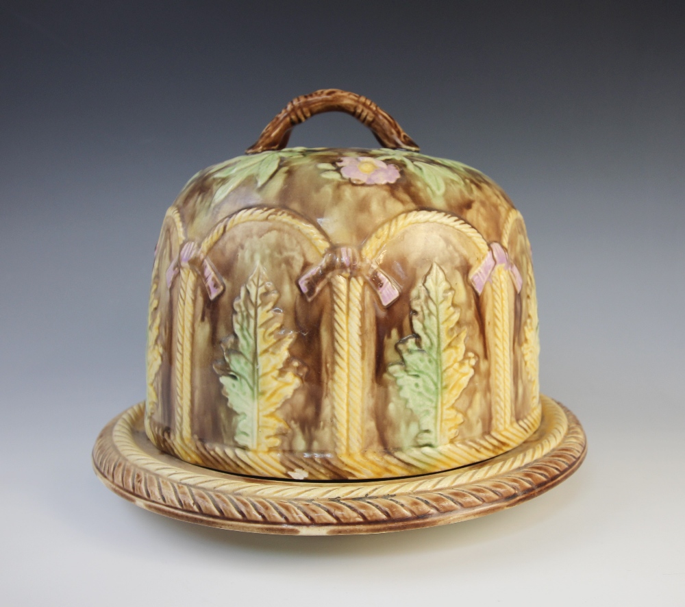 A majolica cheese bell and stand, 19th century, the brown mottled bell with a continuous relief - Image 2 of 3