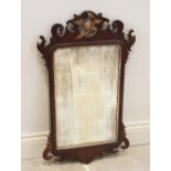 A George III mahogany fretwork mirror, with a gilt phoenix crest above a rectangular mirrored plate,