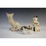 A Staffordshire model of a recumbent cat, with sponged tortoiseshell decoration, moulded T to