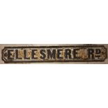 A vintage cast iron wall mounted 'Ellesmere Road' sign, the relief cast lettering painted black upon
