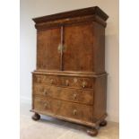 A 17th century and later walnut veneered cabinet on chest of Dutch influence, the moulded cornice