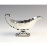 A George V silver sauce boat by Harrison Brothers & Howson, London 1911, of faceted form on raised