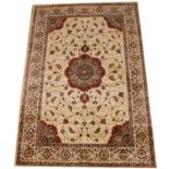 A full pile Kashmir carpet, with a floral medallion design against a gold coloured ground, 240cm x