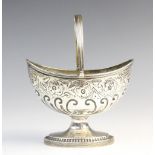 A George III silver swing-handled sweetmeat basket by Crispin Fuller, London 1794, of oval form on