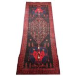 A Naravan vintage village wool runner, heavy pile deep ground with a unique medallion design,