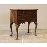 A George III figured walnut low boy, of cottage proportions, the veneered and moulded rectangular