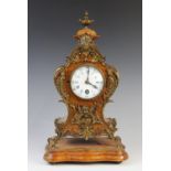 A late 19th century French walnut and gilt metal mantel clock, of waisted form with gilt metal