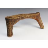 An East African Kenyan Rendille tribal headrest or low stool, 39cm wide