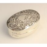 A Victorian silver pill box by William Hutton & Sons, London 1899, of convex oval form, the hinged