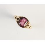 A pink garnet set ring, the central emerald cut pink garnet, within a claw setting,