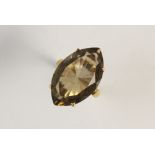 A smokey quartz dress ring, the mixed cut marquise shaped smokey quartz (measuring 25mm x 10mm),