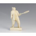 A North American Inuit marine ivory carved standing figure with a club, circa 1900, 8cm high