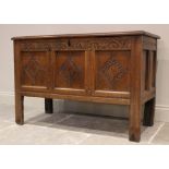 A late 17th/early 18th century oak coffer, with a carved frieze over three panels incised with a
