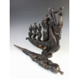 An Indonesian Batak soul catcher spirit boat, 43cm long, and a carved Batak staff, 70cm long (2)