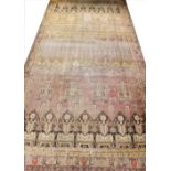 A large Turkish hand woven wool carpet, in brown cream and coral colourways, 287cm x 565cm