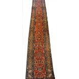 A large Turkish geometric runner, with a traditional repetitive medallion design against a