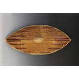 An East African Uganda Ganda wicker shield with handle, 58cm wide