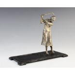 Golfing interest; An Art Deco Ronson desk stand, modelled as a nickel-plated lady golfing, supported