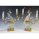 A pair of 18th century style French glass lamps, designed as parrots perched upon urns, in the