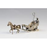 A continental (possibly Dutch) silver model of a horse-drawn sleigh, the coachman modelled with