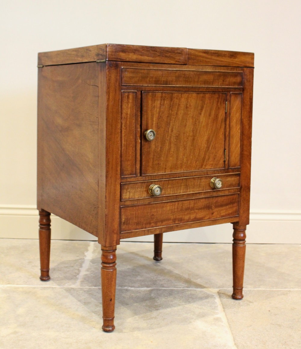 A George III and later mahogany cellarette, converted from a commode chest, the twin hinged top