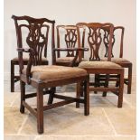 A matched set of five elm and oak George III Chippendale style dining chairs, each with an