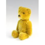 A Schuco perfume bottle bear, mid 20th century, with mohair body, articulated arms and legs, glass