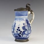 A Dutch tin-glazed earthenware and pewter mounted tankard, 18th century, the bell-shaped/baluster