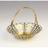 A silver gilt bon-bon basket by Adie Brothers Ltd, Birmingham 1958, of tapered circular form with
