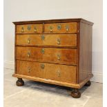 A William and Mary walnut chest, the rectangular top over two short and three graduated long