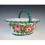 A Wemyss Ware basket, 19th century, of fluted oval form with twisted loop handle, decorated in the