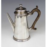 A late Victorian silver hot water jug, marks for 'J.G' London 1899, of tapered cylindrical form with