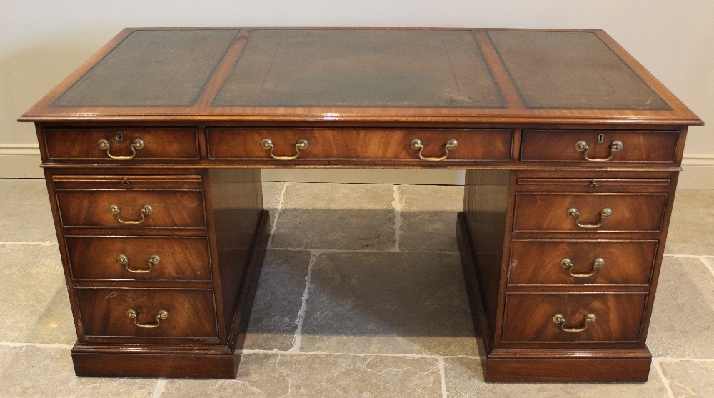 A George III style mahogany twin pedestal desk, late 20th century, the rectangular moulded top