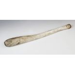 An Inuit Oosik club, walrus baculum (penis bone), 19th century, 48.5cm long overall Provenance:
