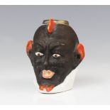 A brass mounted painted vesta pot, probably 19th century, modelled as a devil or demon mask with