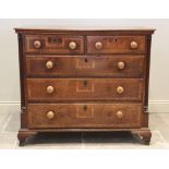 A mid 18th century oak and cross banded chest of drawers, with an arrangement of two short and three