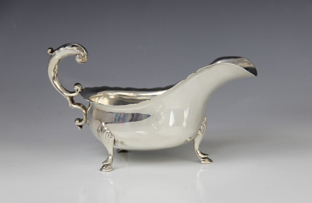 A George V silver sauce boat by Josiah Williams & Co, London 1922, of typical form with shaped rim