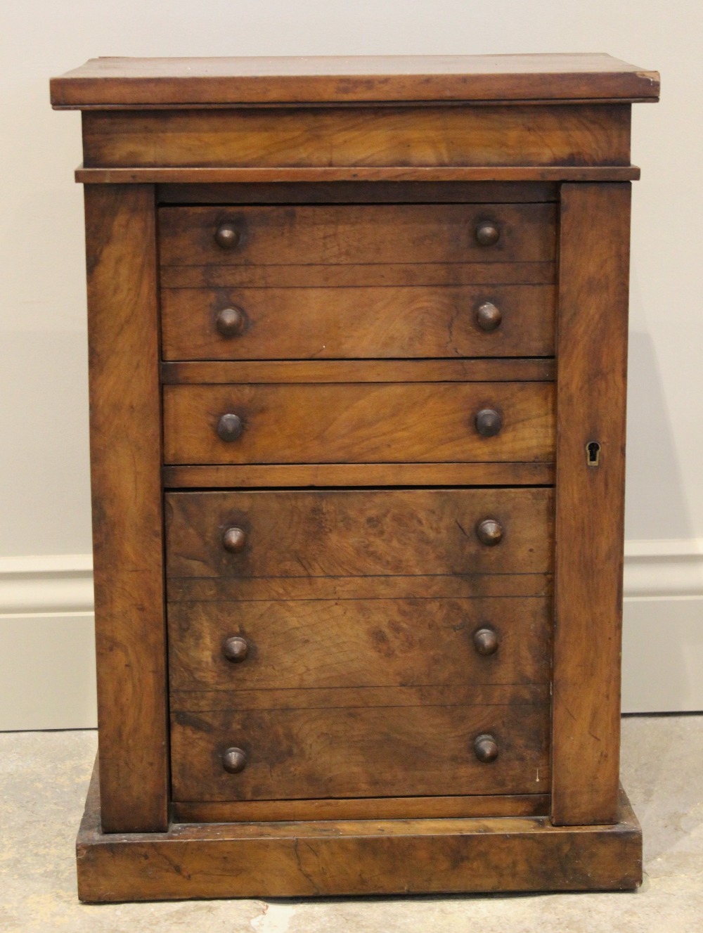 A Victorian figured walnut apprentice Wellington chest, with an arrangement of three drawers, the