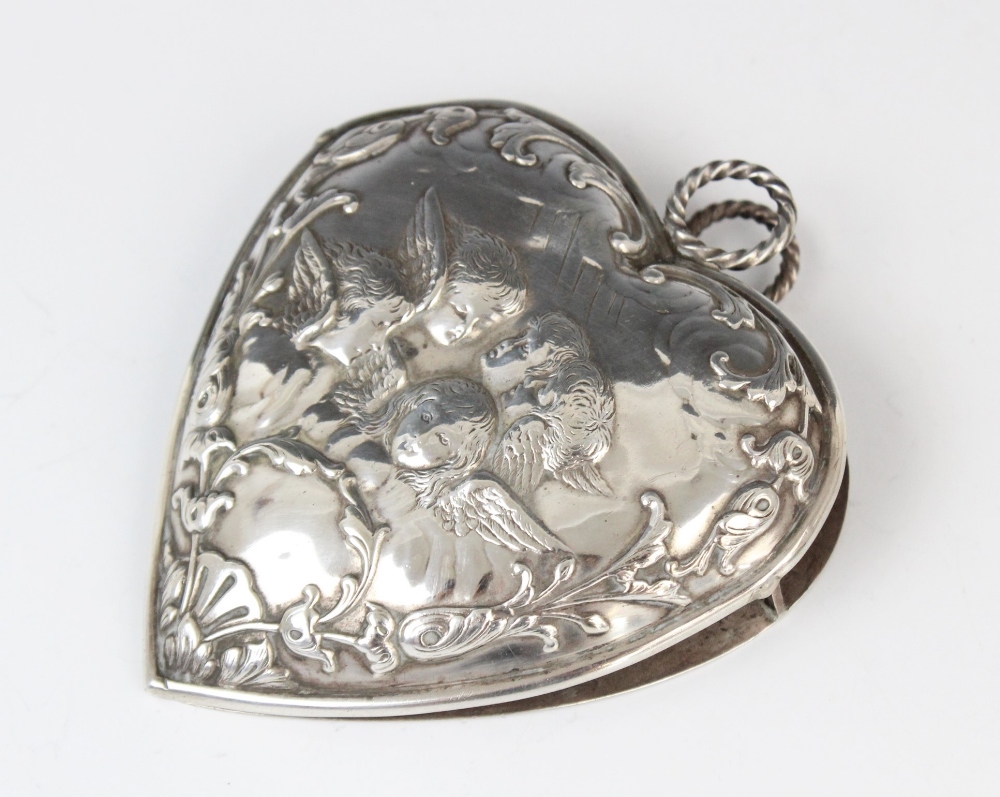 A Victorian silver desk clip by William Comyns, London 1896, in the shape of a heart decorated