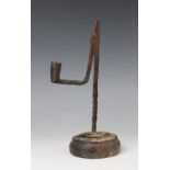 A wrought iron rush lamp, probably 18th century, one arm of the scissor jaws terminating in a