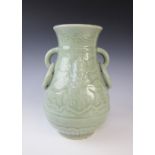 A Chinese celadon glazed ring handled vase, 20th century, of baluster form and decorated with floral